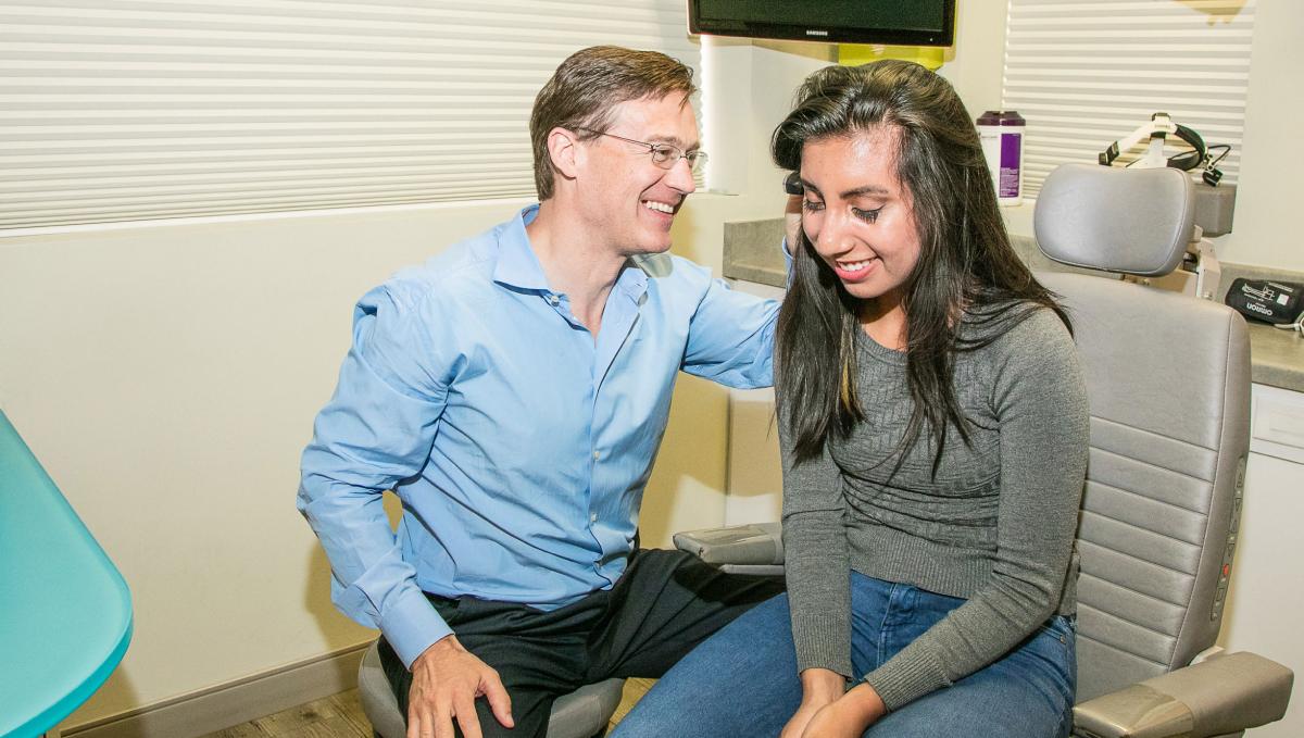 An audiologist examining a patient's ear